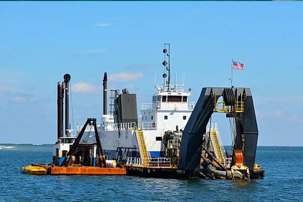 Industrial Barge with an Excavator on the Sea